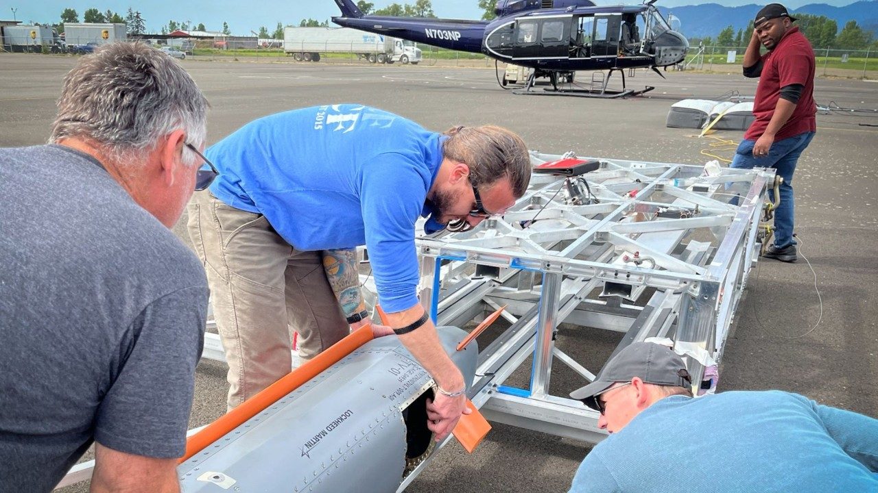 Engineers guide the CMMT-D test missile into a Rapid Dragon cell on an Oregon flight line